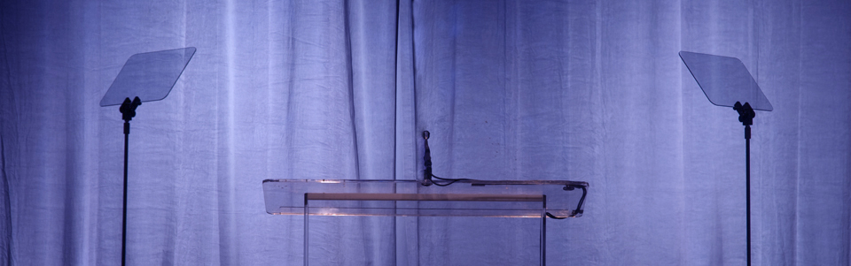 A presidential prompter and clear lectern on a corporate event.